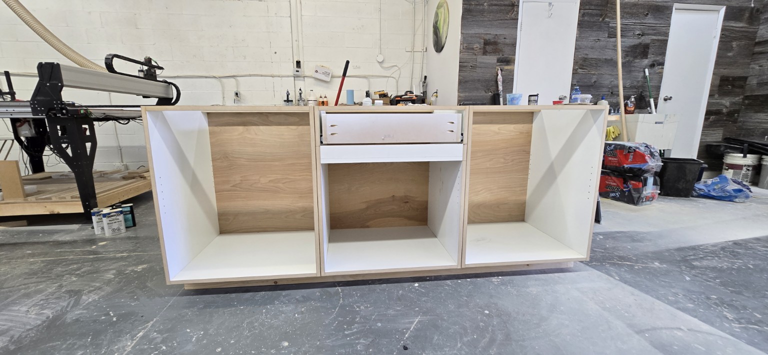 Wide view of MDF closet cabinetry with birch plywood back panels in the Miter5 shop