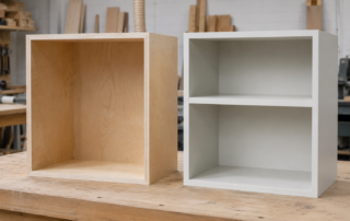 Painted MDF cabinet beside a prefinished birch plywood cabinet in a professional workshop