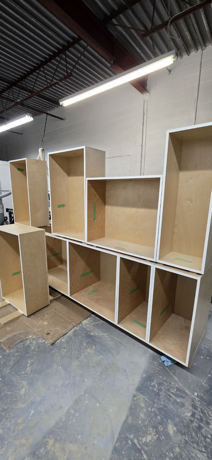Multiple prefinished birch plywood cabinet boxes manufactured for kitchen and laundry rooms